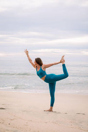 Jonna Monola wearing blue high waisted yoga leggings and blue yoga top 