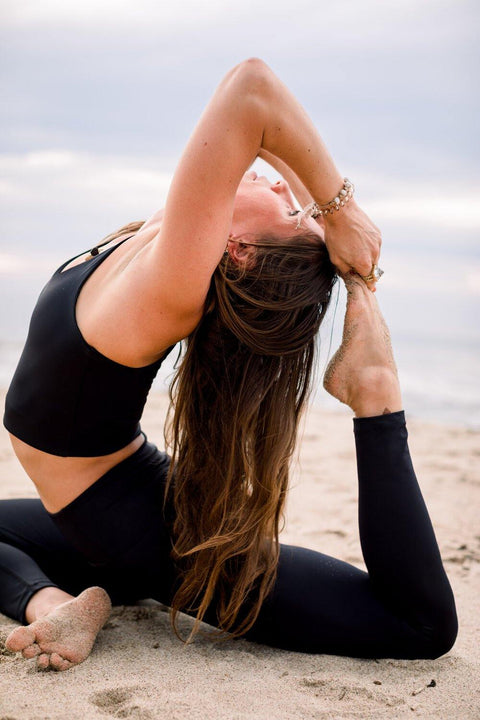 Yogini in black yoga top and super high waist black yoga leggings