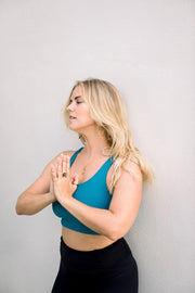 Eva Estlander wearing ocean blue yoga top and black high waisted yoga leggings Moonah Wear