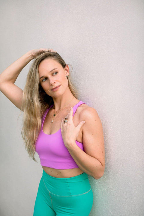 Audra Rose Stanley wearing Moonah Wear sustainable pink yoga top and turquoise leggings